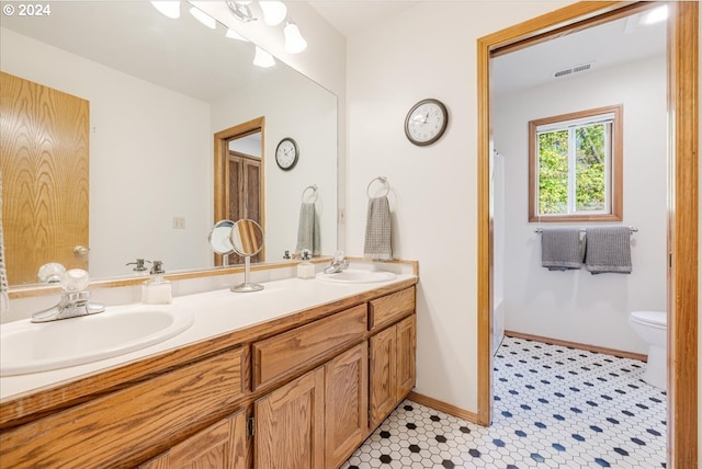 full bathroom featuring vanity, toilet, shower with separate bathtub, and tile patterned flooring