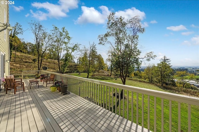 wooden deck featuring a yard