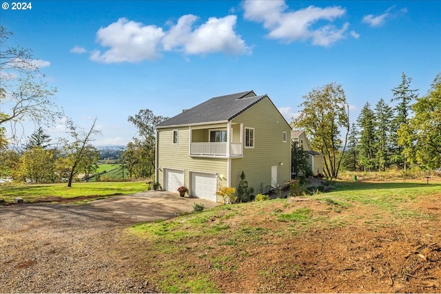 view of home's exterior with a garage and a lawn