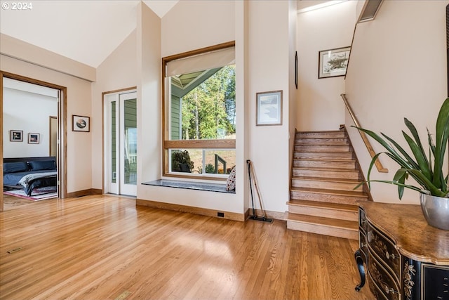 interior space featuring high vaulted ceiling and light hardwood / wood-style floors