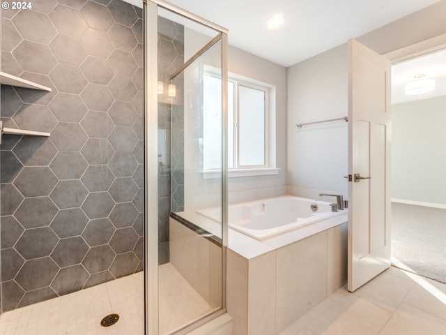 bathroom with tile patterned flooring and independent shower and bath