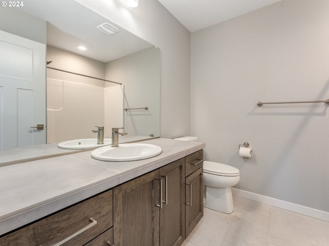 bathroom featuring tile patterned floors, toilet, a shower, and vanity