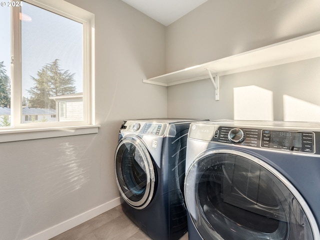 clothes washing area with washing machine and dryer