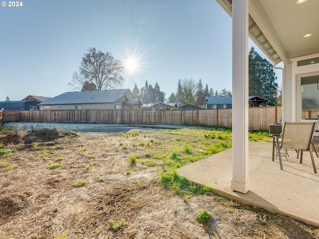 view of yard with central AC unit and a patio