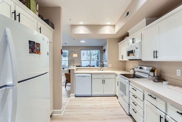 kitchen with white cabinets and white appliances