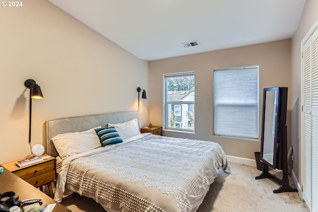 carpeted bedroom featuring a closet