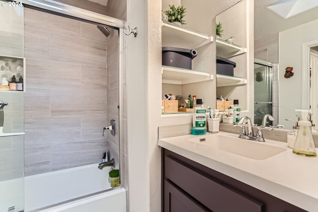 bathroom featuring shower / bath combination with glass door and vanity