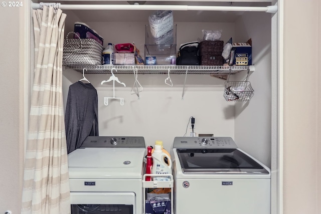 laundry area with washing machine and clothes dryer