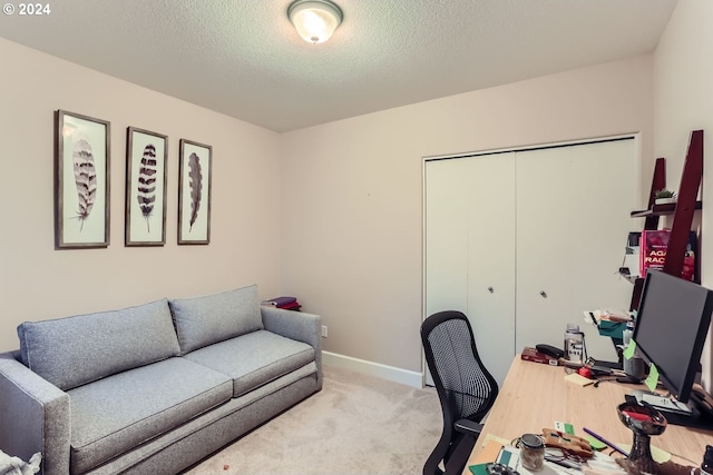 carpeted home office with a textured ceiling