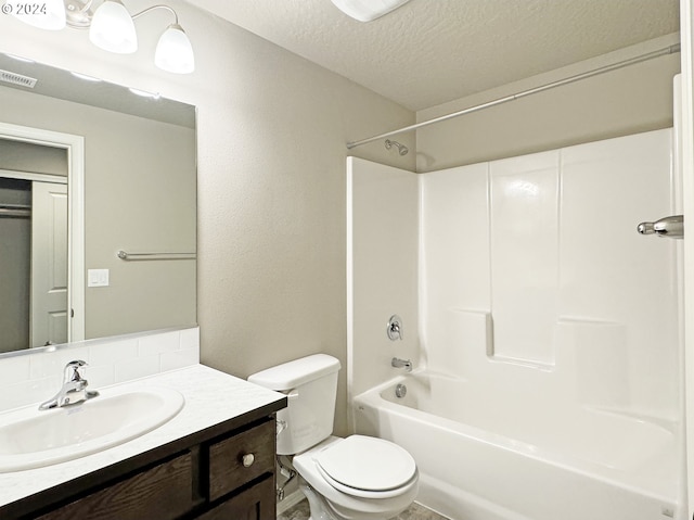 full bathroom with vanity, shower / bathtub combination, toilet, and a textured ceiling