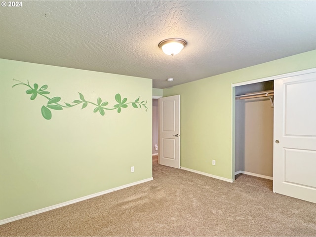 unfurnished bedroom with a textured ceiling, light carpet, and a closet