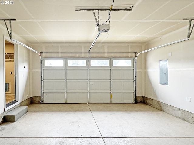 garage with electric panel and a garage door opener