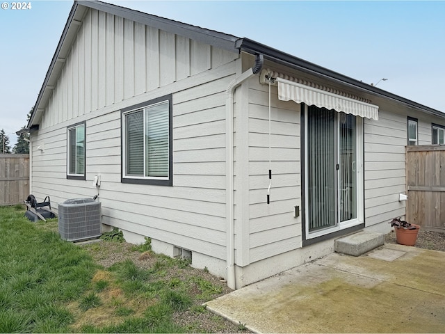 view of side of home featuring central air condition unit