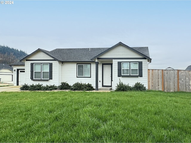 single story home featuring a garage and a front lawn