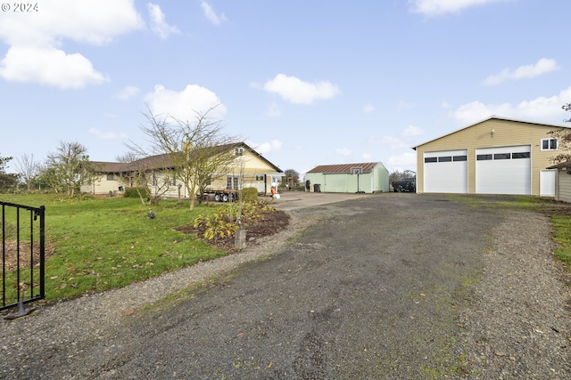 exterior space featuring a front yard, an outdoor structure, and a garage