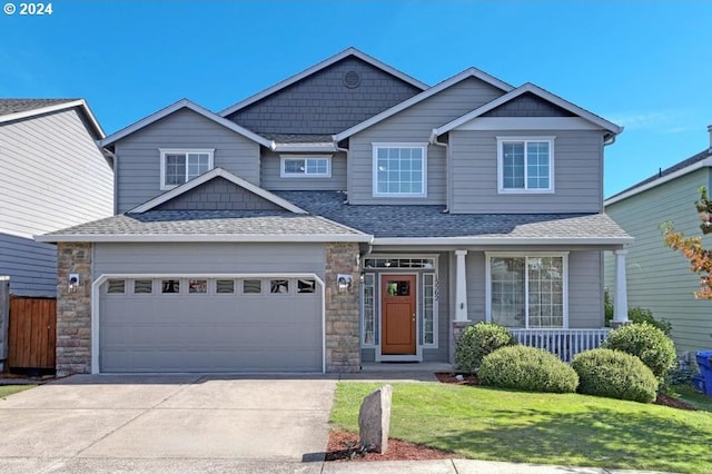 craftsman-style home featuring a front yard and a garage