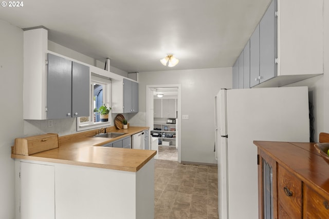 kitchen with white appliances, sink, and tasteful backsplash