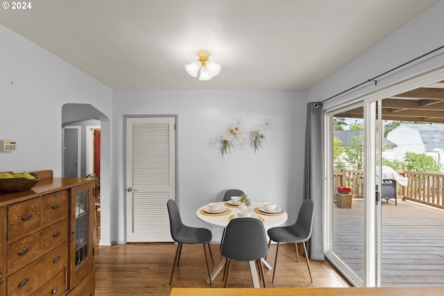 dining room with wood-type flooring and beverage cooler