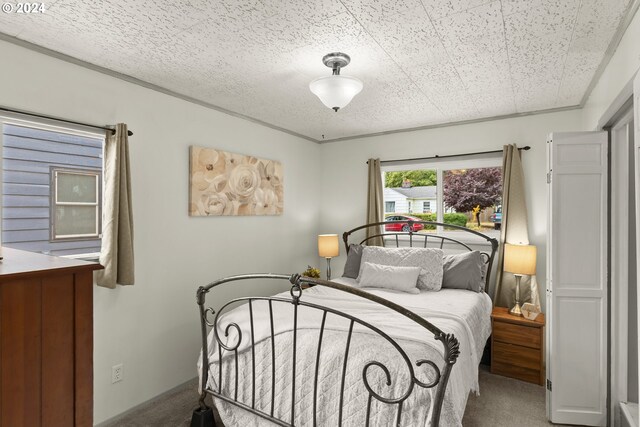 carpeted bedroom featuring a textured ceiling