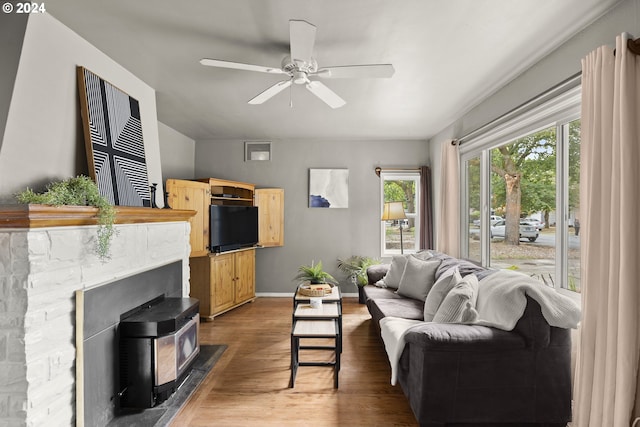 living room with ceiling fan, hardwood / wood-style floors, and a fireplace