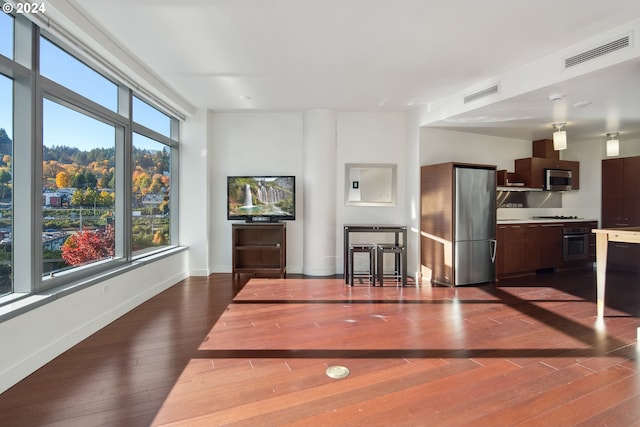 unfurnished dining area with dark hardwood / wood-style floors and a wealth of natural light