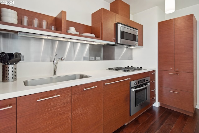 kitchen with sink, dark hardwood / wood-style flooring, and appliances with stainless steel finishes