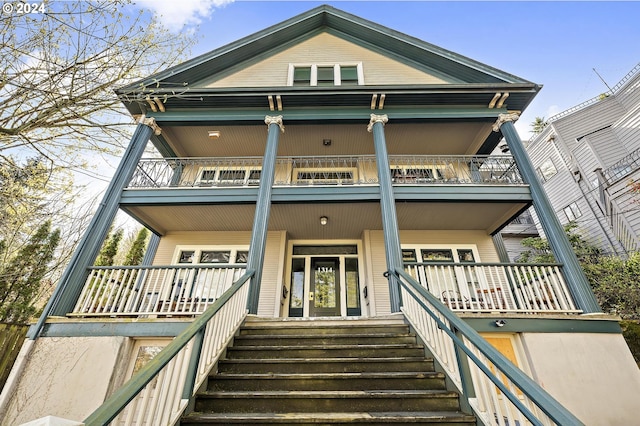 view of front of house featuring a balcony and covered porch