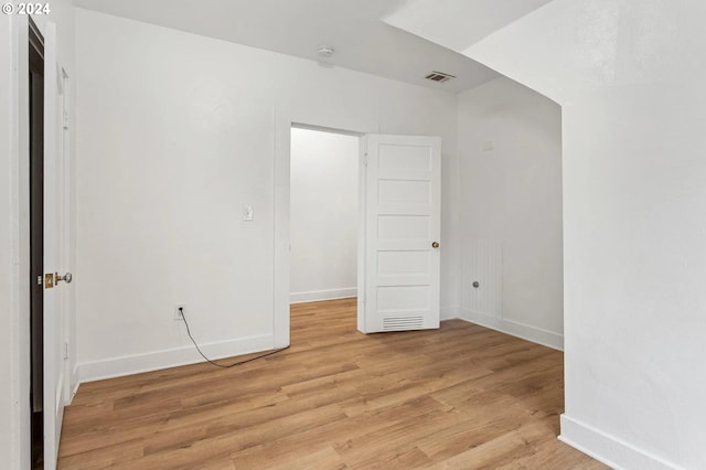 empty room with light hardwood / wood-style flooring