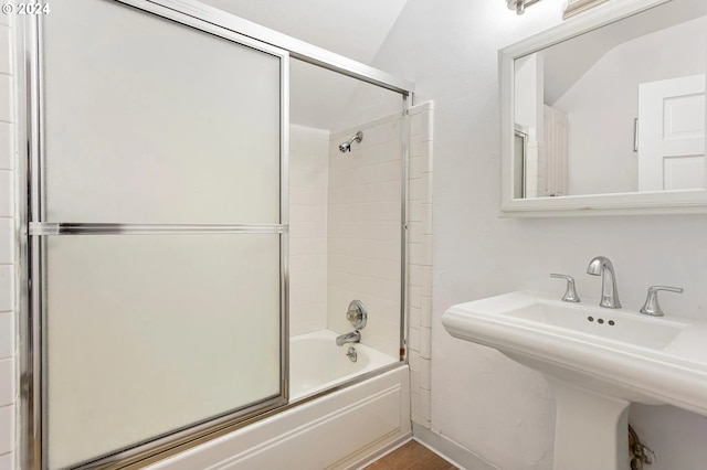 bathroom with combined bath / shower with glass door and sink