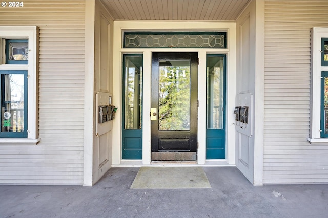 view of exterior entry featuring a porch