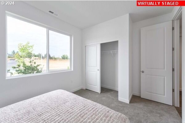 carpeted bedroom with a closet