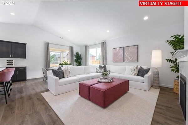 living room featuring vaulted ceiling and dark hardwood / wood-style flooring