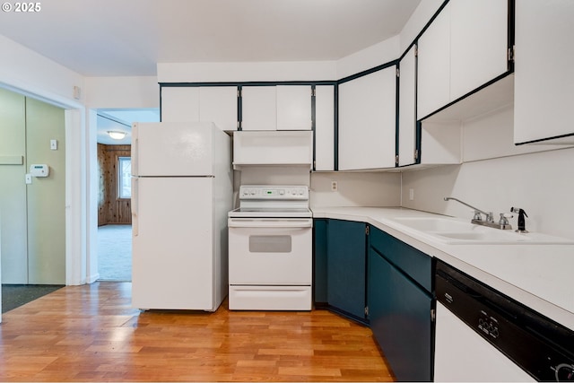 kitchen with sink, blue cabinets, white cabinets, white appliances, and light hardwood / wood-style flooring