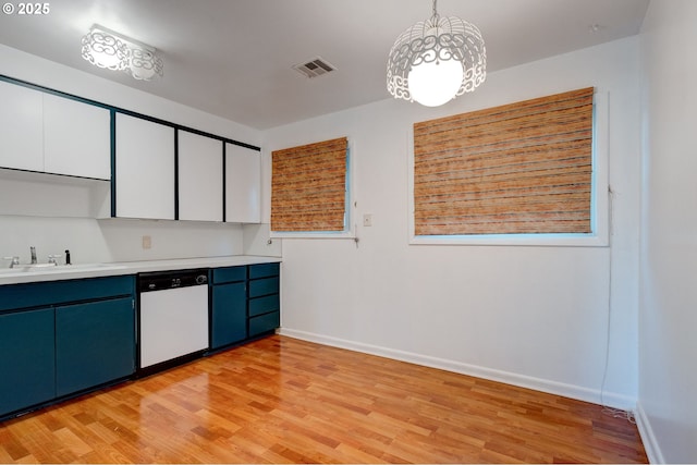 kitchen featuring decorative light fixtures, light wood-type flooring, white cabinetry, white dishwasher, and sink