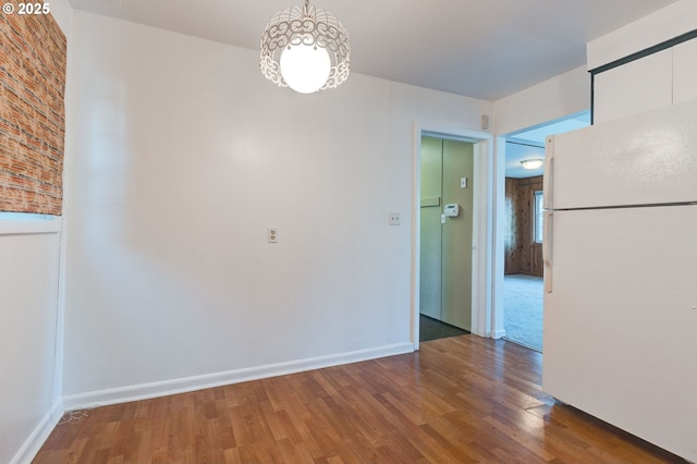 unfurnished dining area with wood-type flooring