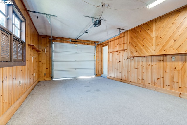 garage with a garage door opener and wooden walls