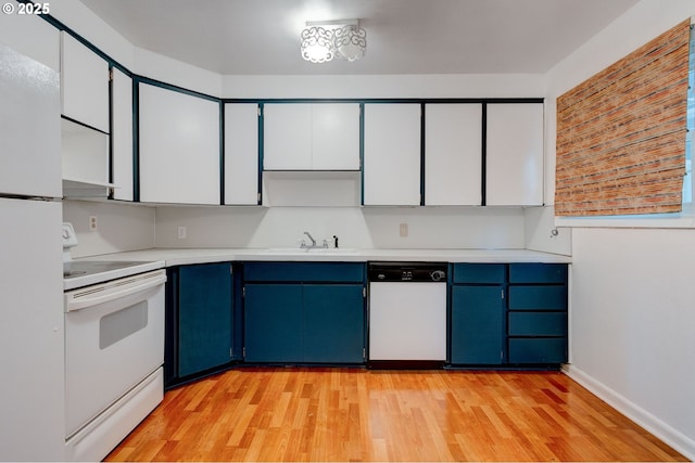 kitchen featuring white appliances, sink, blue cabinets, and white cabinetry