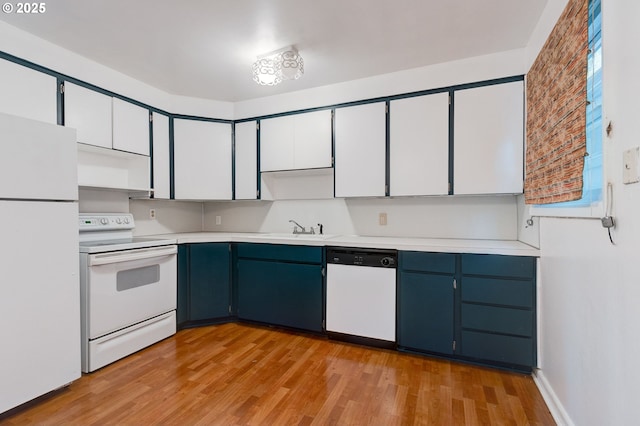 kitchen featuring white appliances, white cabinetry, blue cabinetry, sink, and light hardwood / wood-style flooring