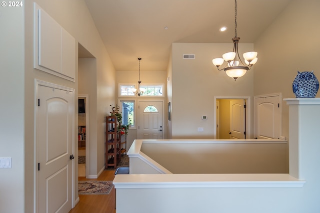 entrance foyer featuring visible vents, light wood-type flooring, recessed lighting, a high ceiling, and an inviting chandelier