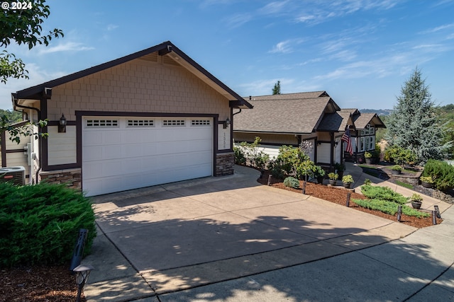 view of front facade featuring a garage and stone siding