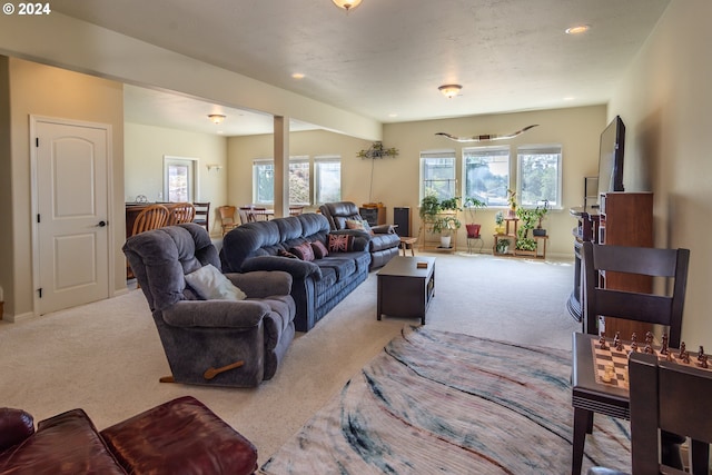 carpeted living room with recessed lighting and baseboards