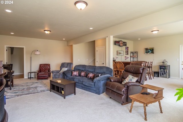 living room with recessed lighting, baseboards, and light carpet