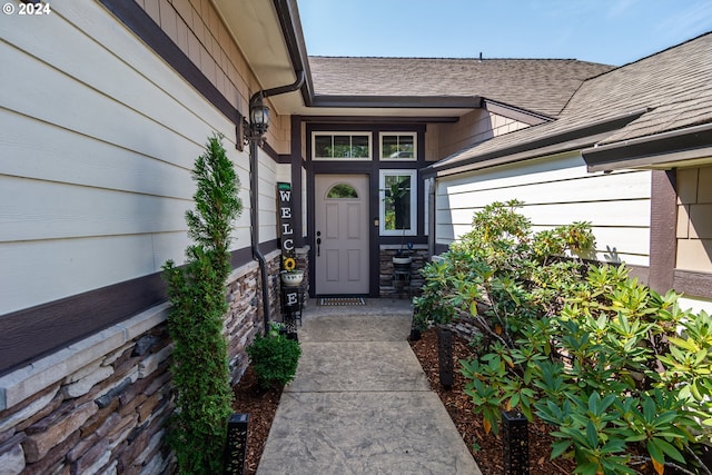 property entrance with stone siding