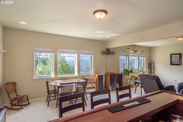 carpeted dining area with baseboards