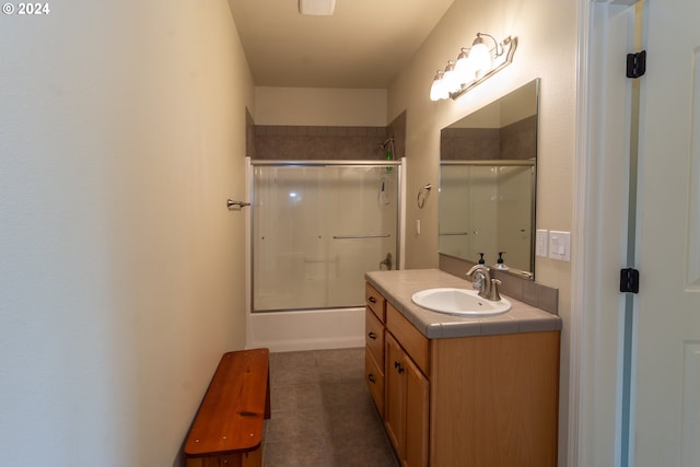 bathroom featuring vanity, tile patterned floors, and bath / shower combo with glass door