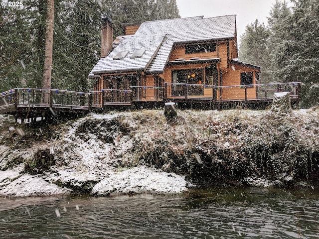 back of property with a water view