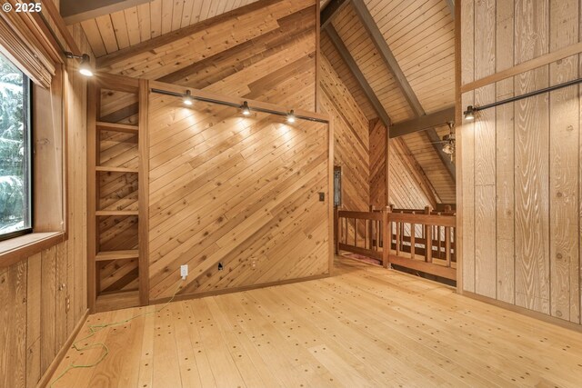 bonus room featuring wood-type flooring, wood ceiling, wood walls, and a healthy amount of sunlight