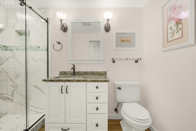 bathroom with vanity, wood-type flooring, a shower with shower door, and toilet