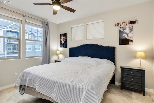 bedroom featuring ceiling fan and light carpet