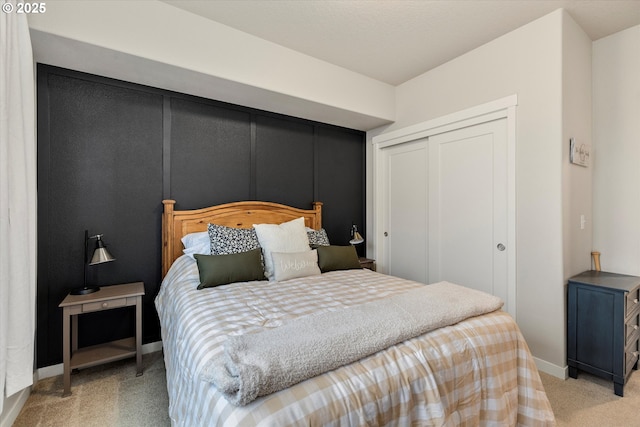 bedroom featuring light carpet and a closet